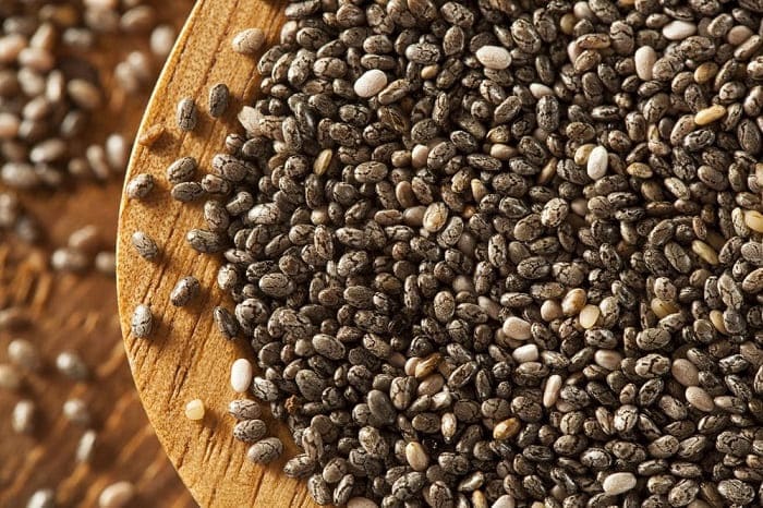 Organic Dry Black Chia Seeds in wooden tray