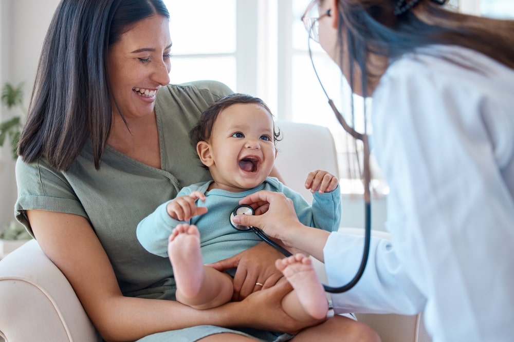 Pediatrics Doctor examine happy infant kid chest in gondal hospital